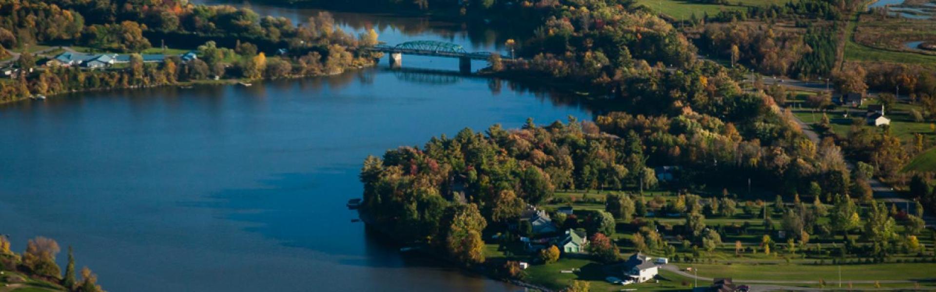 Aerial view of a river running through town. 