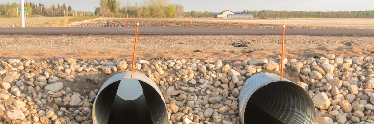 2 culvarts on a road with fields behind