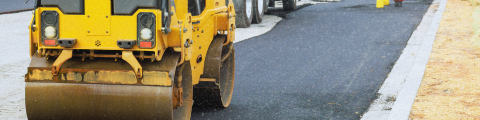 An asphalte truck leveling the surface