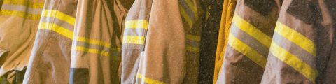 6 firefighters coats placed on a rack