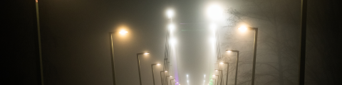 A dozen of street lights following a path